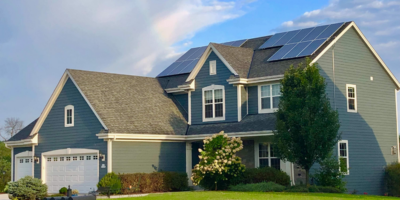 1 A two story single family home with two solar arrays on the roof